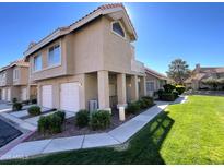 Inviting two-story home with a well-manicured lawn and lovely desert landscaping at 1633 E Lakeside Dr # 154, Gilbert, AZ 85234
