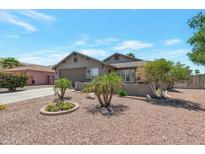 Charming single-story home with a well-manicured desert landscape and a two-car garage at 16461 W Central St, Surprise, AZ 85388