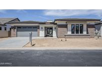 Stunning single-story home with a large garage, neutral color palette, and desert landscaping in a suburban neighborhood at 24000 S 218Th Pl, Queen Creek, AZ 85142