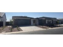 Beautiful single-story home with a modern design, well-maintained landscaping, and a two-car garage at 24000 S 218Th Pl, Queen Creek, AZ 85142