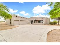 Charming stucco home featuring a spacious driveway, an attached two-car garage and decorative wood beam accents at 27347 N Gary Rd, San Tan Valley, AZ 85144