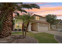Charming two-story home featuring a well-manicured lawn and desert landscaping at 4043 N Ranier --, Mesa, AZ 85215