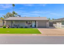 Charming single-story home with a well-manicured lawn and a welcoming entrance at 4137 E Sells Dr, Phoenix, AZ 85018