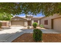 Charming single-story home with landscaped front yard and a two-car garage at 41804 W Carlisle Ln, Maricopa, AZ 85138