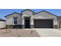 Charming single-story home with a two-car garage, desert landscaping, and a covered entryway at 5806 E Axle Ln, San Tan Valley, AZ 85140
