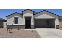 Charming single-story home featuring a low-maintenance yard, two-car garage and covered front entry at 5806 E Axle Ln, San Tan Valley, AZ 85140