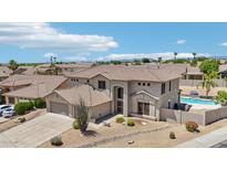 Stunning aerial view of a two-story home with a tile roof, a sparkling pool, and desert landscaping at 7472 E Black Rock Rd, Scottsdale, AZ 85255
