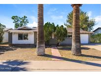 Charming single-story home with mature landscaping and a brick walkway at 8227 E Heatherbrae Dr, Scottsdale, AZ 85251