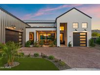 Beautiful modern home with manicured landscaping, brick driveway, and attached two-car garage at 1013 W Ardmore Rd, Phoenix, AZ 85041