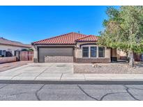 Charming single-story home with a red tile roof, desert landscaping, and a two-car garage at 10541 W Foothill Dr, Peoria, AZ 85383