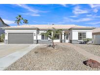 Charming single-story home featuring a well-manicured yard, neutral color palette, and a two-car garage at 1071 N Danyell Dr, Chandler, AZ 85225