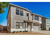 Inviting two-story home featuring a neutral stucco exterior, attached garage, and well-maintained front yard at 11836 W Rosewood Dr, El Mirage, AZ 85335