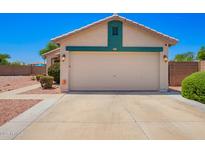 Single Gathering house featuring a two-car garage and well-kept landscaping at 13824 N 148Th Ln, Surprise, AZ 85379