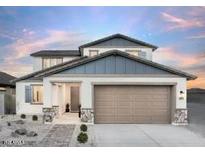Charming two-story home with a two-car garage, stone accents, and a well-manicured front yard at 15159 W Gray Fox Trl, Surprise, AZ 85387