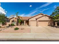Charming home featuring a spacious three-car garage and well-maintained desert landscaping at 18021 N 53Rd St, Scottsdale, AZ 85254
