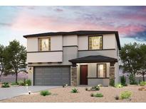 Charming two-story home featuring stone accents, a covered entryway, and low-maintenance desert landscaping at 18147 W Daley Ln, Surprise, AZ 85387