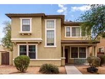 Inviting two-story home with a well-manicured front yard and charming front porch area at 1835 S Rockwell St, Gilbert, AZ 85295