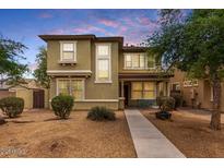 Charming two-story home with a well-maintained lawn and inviting front porch with sidewalk at dusk at 1835 S Rockwell St, Gilbert, AZ 85295