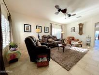 Comfortable living room featuring neutral walls, tile floors, and a ceiling fan for a cozy atmosphere at 18427 E Verde Ct, Gold Canyon, AZ 85118