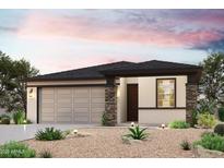 Charming single-story home featuring a two-car garage and decorative stone accents at 1971 S 246Th Ln, Buckeye, AZ 85326