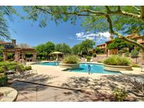 Inviting community pool area with lounging chairs and lush landscaping on a sunny day at 20750 N 87Th St # 1065, Scottsdale, AZ 85255
