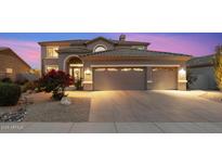 Charming two-story home featuring a three-car garage, desert landscaping and a lovely bougainvillea bush at 22233 N 54Th Way, Phoenix, AZ 85054