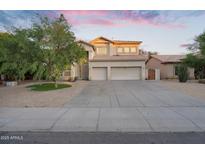 Spacious two-story home with a three-car garage and a well-manicured front yard at 249 E Palomino Ct, Gilbert, AZ 85296