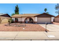 Charming single-story home featuring a decorative front yard with an arched entry and a two-car garage at 3415 E Anderson Dr, Phoenix, AZ 85032