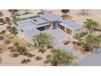 An aerial view of a modern, desert home with a flat roof, stone accents, and desert landscaping at 3648 N Sky Point Cir, Mesa, AZ 85207