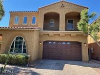 Charming two-story home features a beautiful arched window, balcony, and a two-car garage at 4635 E Casitas Del Rio Dr, Phoenix, AZ 85050