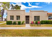 Charming single-story home featuring a stucco exterior, manicured front yard, and cozy patio chairs at 5037 N 81St St, Scottsdale, AZ 85250