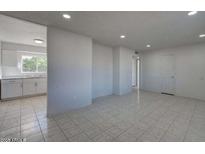 Bright living room features tile flooring, neutral paint, and recessed lighting at 5609 W Encanto Blvd, Phoenix, AZ 85035