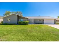 Charming single story home with a well maintained front yard, two car garage, and interesting privacy screen at 6127 N 16Th Pl, Phoenix, AZ 85016