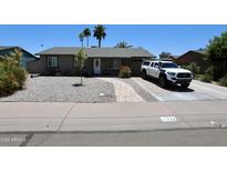 Charming single-story home features desert landscaping, a neutral color scheme and a paved walkway to the front door at 711 W El Alba Way, Chandler, AZ 85225