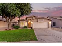 Charming single-Gathering home with a well-maintained lawn, mature tree, and two-car garage at 8319 E Plata Ave, Mesa, AZ 85212