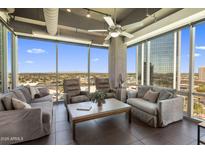 Bright living room with modern furnishings and large windows offering panoramic city views at 1 E Lexington Ave # 1209, Phoenix, AZ 85012