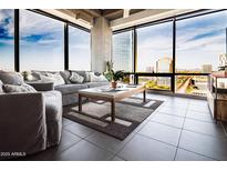 Bright living room featuring floor-to-ceiling windows with a stunning city view and comfortable seating at 1 E Lexington Ave # 1209, Phoenix, AZ 85012