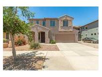 Two-story home with desert landscaping, covered entry, and two car garage at 11834 N 147Th Ln, Surprise, AZ 85379