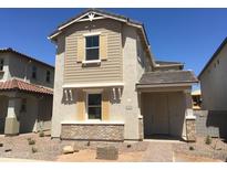 Charming two-story home featuring a neutral color scheme, decorative shutters, and a well-maintained front yard at 13473 N 158Th Ave, Surprise, AZ 85379