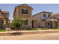 Charming two-story home with neutral stucco, landscaped front yard and covered entrance at 13473 N 158Th Ave, Surprise, AZ 85379