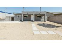 Charming single-story home featuring a minimalist front yard, gray stucco, and a welcoming entrance at 1546 W Pierce St, Phoenix, AZ 85007