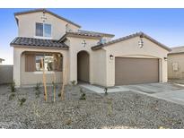 A charming two-story home with a two-car garage, neutral color palette, and minimal landscaping at 19033 W Rose Ln, Waddell, AZ 85355