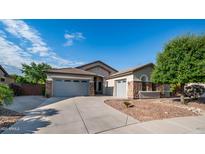 Charming single-story home featuring stone accents, a tile roof, and a spacious three-car garage at 1970 E Yellowstone Pl, Chandler, AZ 85249