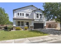 Charming two-story home featuring a well-manicured lawn, covered porch, and a two-car garage at 2562 E Los Alamos St, Gilbert, AZ 85295