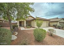Charming single-story home featuring a two car garage and low maintenance desert landscaping at 25729 W St Charles Ct, Buckeye, AZ 85326