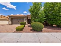 Charming home featuring a tile roof, manicured landscaping, and a spacious two-car garage at 2604 W Balao Dr, Phoenix, AZ 85085