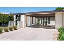 A covered carport and driveway with a modern design create an inviting entrance to this well-landscaped home at 4336 E Piccadilly Rd, Phoenix, AZ 85018