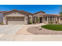 Charming single-story home featuring a two-car garage, desert landscaping, and a stone facade at 4626 E Blue Spruce Ln, Gilbert, AZ 85298