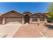 Charming single-story home with a two-car garage, well-kept landscape, and neutral colored stucco at 4826 W Ardmore Rd, Laveen, AZ 85339