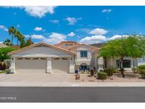 Charming home featuring a three-car garage, desert landscaping, and a pristine stucco exterior under a sunny sky at 5510 W Arrowhead Lakes Dr, Glendale, AZ 85308